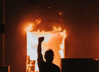 The Wind Blows Hard Against His White Fence