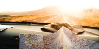 Who Will Find Us? person holding blue and brown map