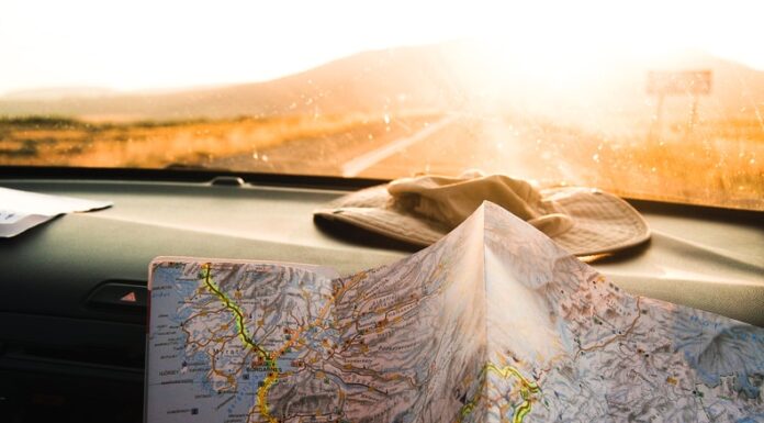 Who Will Find Us? person holding blue and brown map