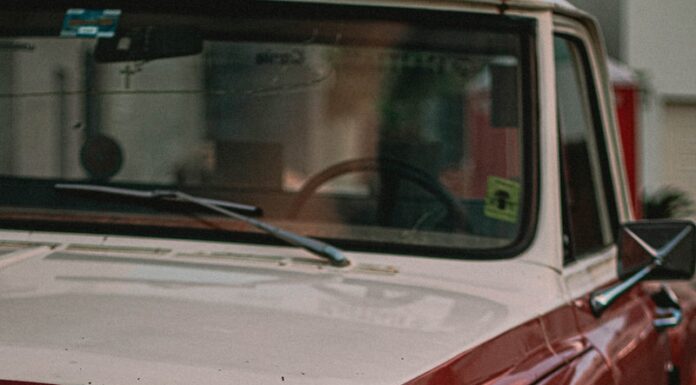 Parking Space shallow focus photo of red single-cab truck
