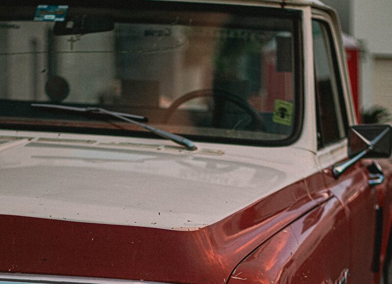 shallow focus photo of red single-cab truck