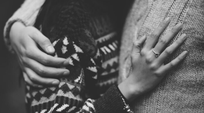 The Business of Life and Death man and woman embracing