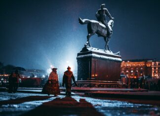 The year of the tyrant’s final spring two person walking near person riding horse statue