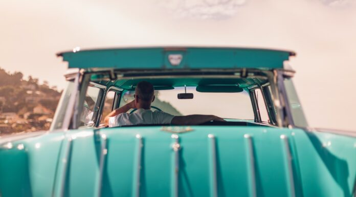 Liberated Me selective focus photography of person riding teal car