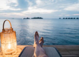 When We Were Poets person lying on chair and facing on body of water