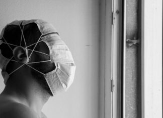 BACK IN THE EARLY DAYS OF COVID grayscale photo of person wearing white and black hat