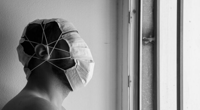 BACK IN THE EARLY DAYS OF COVID grayscale photo of person wearing white and black hat