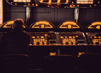 At the Casino with No Money man playing arcade machine