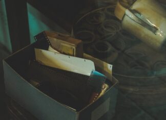 Certificate of achievement white and black box on black table