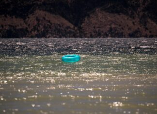 Calm enough blue plastic round lid on water