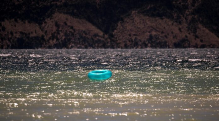 Calm enough blue plastic round lid on water