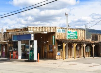 Bottom feeding at the gas station slots brown and white concrete building during daytime