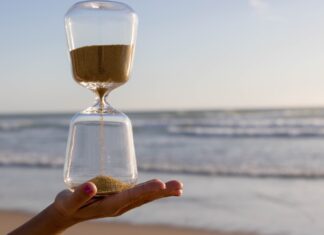 A Conversation at the Age Desk clear hour glass on persons hand