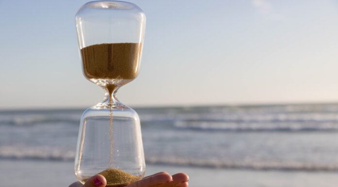 A Conversation at the Age Desk clear hour glass on persons hand