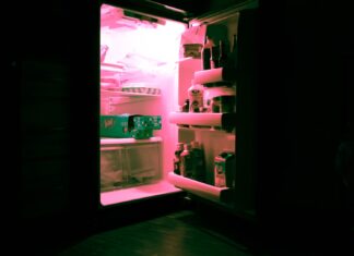 summer heat opened refrigerator filled with bottles