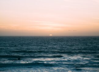 After the Visit sea waves under sunset