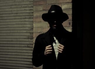 6:09 a.m. man wearing black fedora hat and black suit jacket