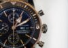 Moments round black and gold-colored Brietling chronograph watch