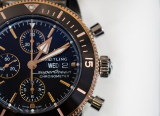 Moments round black and gold-colored Brietling chronograph watch