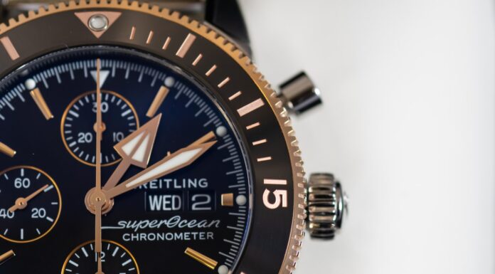 Moments round black and gold-colored Brietling chronograph watch