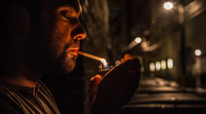 I HAD TO LIGHT A SECOND CIGARETTE man lighting up flip-top lighter for cigar