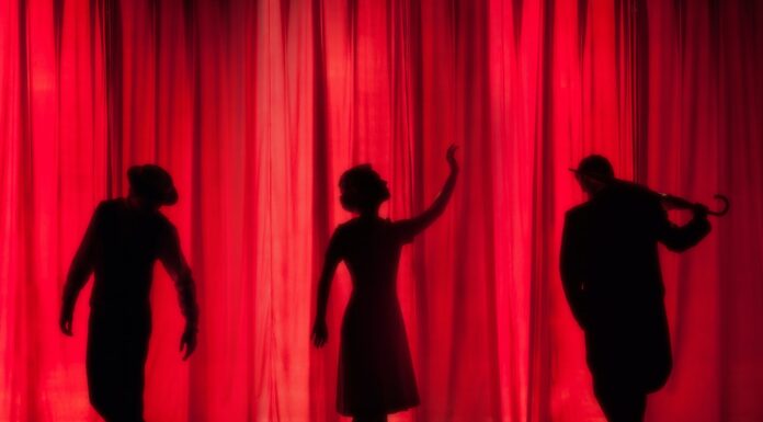 performance silhouette of three performers on stage