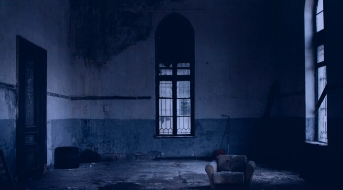 Divine Sequence white padded armchair near glass window