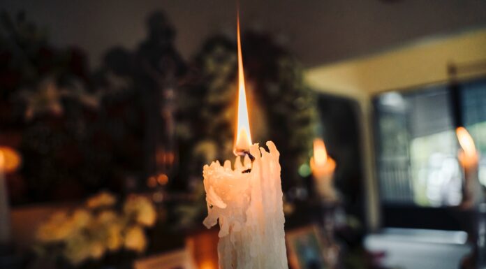 News of the Apocalypse white candle in a room