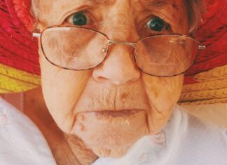 her mouth woman in white top wearing eyeglasses