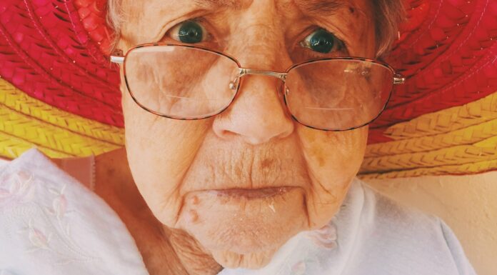 her mouth woman in white top wearing eyeglasses