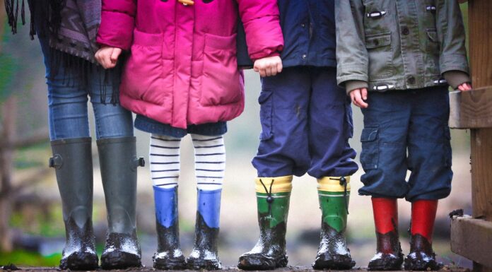 The First Lesson four children standing on dirt during daytime