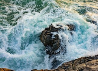 Tides high angle photography of waves on gray stone