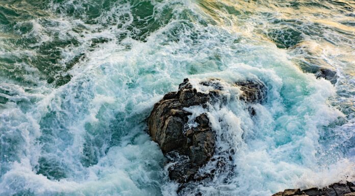 Tides high angle photography of waves on gray stone