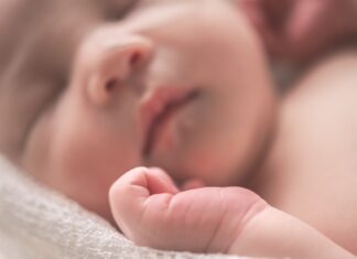 A Tyre Changer Can Earn £350k per year sleeping baby on white textile