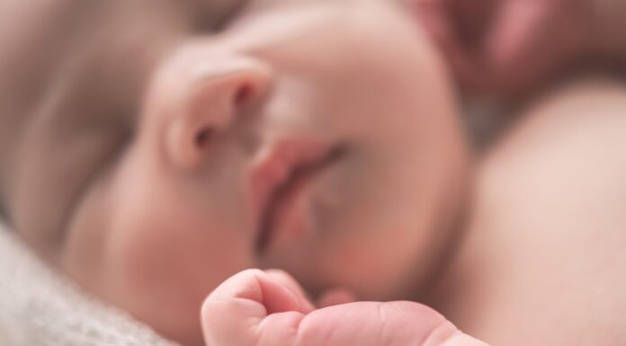 A Tyre Changer Can Earn £350k per year sleeping baby on white textile