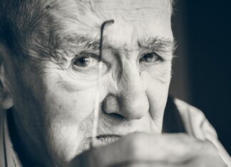 MY PAPAP IS IN THE HOSPITAL grayscale photo of a man holding eyeglasses