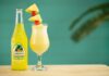 Piña Colada clear glass bottle with yellow liquid inside