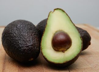 When I Am Old sliced avocado fruit on brown wooden table