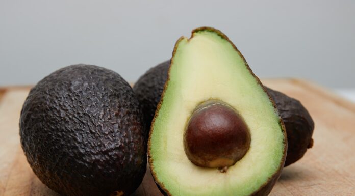 When I Am Old sliced avocado fruit on brown wooden table