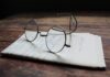 Restraint, a How-To silver framed eyeglasses on white printer paper