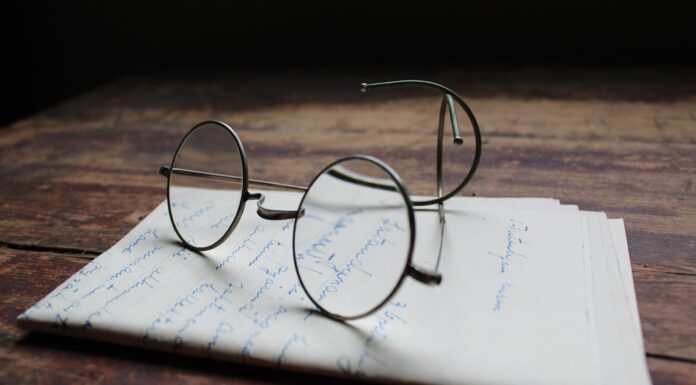 Restraint, a How-To silver framed eyeglasses on white printer paper
