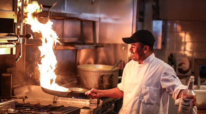 Myrna in the Checkout Lane man in white chef uniform cooking