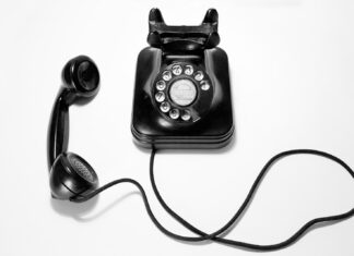 New Haiku black rotary dial phone on white surface