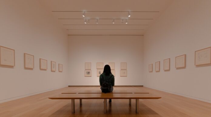 Tat Tvam Asi man in black jacket sitting on brown wooden bench