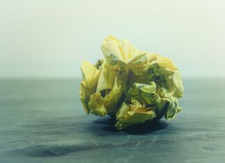 Presence crumpled yellow ruled paper on gray panel