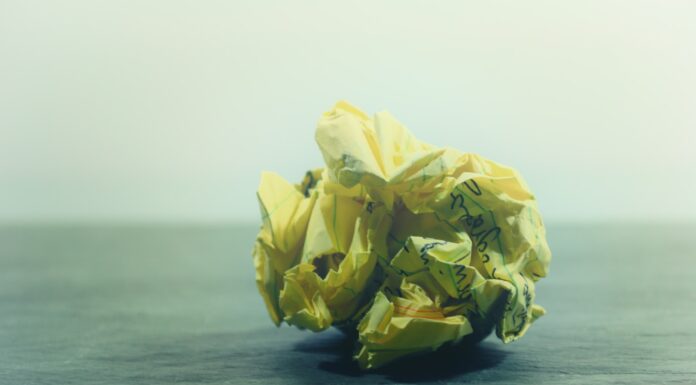 Presence crumpled yellow ruled paper on gray panel