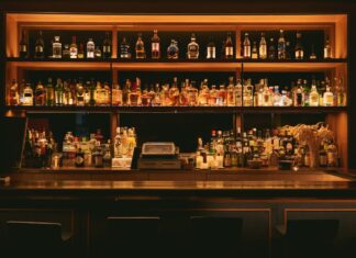 The Finest Spirits brown wooden shelf with bottles