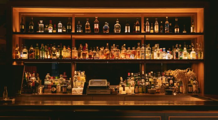 The Finest Spirits brown wooden shelf with bottles