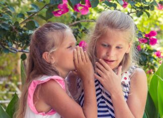 Epiphany girl in pink tank top beside girl in blue and white striped tank top