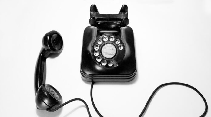 A dram for you, a dram for me black rotary dial phone on white surface